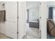 View into the bedroom with a single bed, neutral colors, and natural lighting at 33524 Elm Hill Br, Wesley Chapel, FL 33545