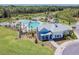 Aerial view of the clubhouse with a pool in the background, offering a great community space and amenities at 33524 Elm Hill Br, Wesley Chapel, FL 33545