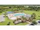Aerial view of a community pool, patio area and clubhouse surrounded by palm trees and lush landscaping at 33524 Elm Hill Br, Wesley Chapel, FL 33545