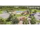 Aerial view of community pool, playground, basketball court, and pond providing a variety of recreational activities at 33524 Elm Hill Br, Wesley Chapel, FL 33545