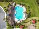 Overhead view of a community pool, splash pad, and play area nestled amidst lush landscaping and outdoor enjoyment at 33524 Elm Hill Br, Wesley Chapel, FL 33545