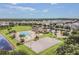 Aerial shot of a community pool, splash pad, and basketball court surrounded by lush landscaping and inviting common areas at 33524 Elm Hill Br, Wesley Chapel, FL 33545