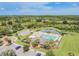 Aerial view showcasing the pool, tennis courts, playground and other community amenities at 33524 Elm Hill Br, Wesley Chapel, FL 33545