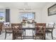 Dining room with hardwood table and chairs, contemporary light fixture, and sliding doors at 33524 Elm Hill Br, Wesley Chapel, FL 33545