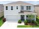 Beautiful two-story home featuring an attached two-car garage and welcoming front porch at 33524 Elm Hill Br, Wesley Chapel, FL 33545