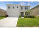 Charming two-story home with a well-maintained lawn and attached garage at 33524 Elm Hill Br, Wesley Chapel, FL 33545