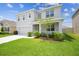 Charming two-story home with a well-maintained lawn and attached garage at 33524 Elm Hill Br, Wesley Chapel, FL 33545
