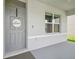 Inviting entryway with a gray front door and a decorative 'Welcome' sign at 33524 Elm Hill Br, Wesley Chapel, FL 33545