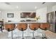 Kitchen island featuring seating, granite countertops, stainless steel appliances, and dark wood cabinetry at 33524 Elm Hill Br, Wesley Chapel, FL 33545