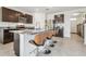 Kitchen island with granite countertops, stainless steel appliances, and modern barstools at 33524 Elm Hill Br, Wesley Chapel, FL 33545