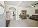 Open-concept living room featuring tile flooring, a bookshelf, and comfortable seating at 33524 Elm Hill Br, Wesley Chapel, FL 33545