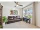 Bright living room with a large window, comfortable seating, and stylish decor at 33524 Elm Hill Br, Wesley Chapel, FL 33545