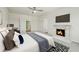 Comfortable bedroom showcasing a cozy fireplace and a modern ceiling fan for relaxing at 33524 Elm Hill Br, Wesley Chapel, FL 33545