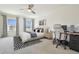 Spacious bedroom with a ceiling fan, windows, plush carpet, and a computer desk at 33524 Elm Hill Br, Wesley Chapel, FL 33545