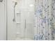 Modern shower with glass door, rainfall shower head and built-in shelving for a spa-like experience at 33524 Elm Hill Br, Wesley Chapel, FL 33545