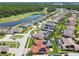 Stunning aerial view of a residential community with golf course, lake, and homes with pools and solar panels at 3737 Gaviota Dr, Sun City Center, FL 33573