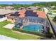 Overhead view of a home with a red tile roof, solar panels and screened in pool and patio area at 3737 Gaviota Dr, Sun City Center, FL 33573