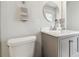 Clean and bright bathroom features a modern vanity and a stylish round mirror, creating a serene space at 3737 Gaviota Dr, Sun City Center, FL 33573