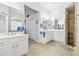 Bathroom featuring double sinks, walk-in shower, and linen closet at 3737 Gaviota Dr, Sun City Center, FL 33573