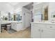 Well-lit bathroom features double vanity with framed mirrors and ample storage at 3737 Gaviota Dr, Sun City Center, FL 33573