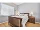 Bedroom with neutral gray walls, wood floors, and wooden furniture at 3737 Gaviota Dr, Sun City Center, FL 33573