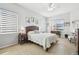 Bright bedroom featuring a ceiling fan, tiled floor, and picturesque windows at 3737 Gaviota Dr, Sun City Center, FL 33573