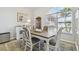 Elegant dining area with a classic table setting and ample natural light from a large window at 3737 Gaviota Dr, Sun City Center, FL 33573