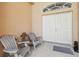 Cozy front porch with double doors and seating area, offering a warm welcome at 3737 Gaviota Dr, Sun City Center, FL 33573