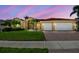 Inviting home exterior featuring a beautiful tiled roof, a two-car garage, and palm trees at 3737 Gaviota Dr, Sun City Center, FL 33573