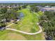 Picturesque aerial view of a meticulously maintained golf course with winding fairways and serene ponds at 3737 Gaviota Dr, Sun City Center, FL 33573