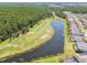 Elevated shot showcasing the golf course and its stunning location with a pond running alongside residences at 3737 Gaviota Dr, Sun City Center, FL 33573