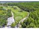 Scenic aerial view of a lush golf course surrounded by trees and landscaping, perfect for recreation at 3737 Gaviota Dr, Sun City Center, FL 33573
