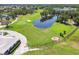 Aerial view of a picturesque golf course, lakes, and surrounding greens offer beauty and recreational opportunities at 3737 Gaviota Dr, Sun City Center, FL 33573