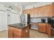 Well-appointed kitchen with stainless steel appliances, island with granite countertops, and ample cabinet space at 3737 Gaviota Dr, Sun City Center, FL 33573