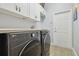 Functional laundry room equipped with modern washer and dryer, providing convenience and efficiency for laundry tasks at 3737 Gaviota Dr, Sun City Center, FL 33573