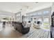 Bright and open living room featuring multiple seating areas and large windows at 3737 Gaviota Dr, Sun City Center, FL 33573