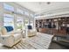 Spacious living room featuring vaulted ceilings, large windows, and built-in shelving at 3737 Gaviota Dr, Sun City Center, FL 33573