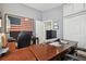 Spacious office with wood floors, a large desk, and an American flag on the wall at 3737 Gaviota Dr, Sun City Center, FL 33573