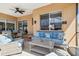 Inviting patio features comfortable seating and a ceiling fan, perfect for relaxing and enjoying the outdoors at 3737 Gaviota Dr, Sun City Center, FL 33573