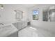 Elegant primary bath boasting marble floors, dual vanities, and natural light at 403 E Davis Blvd, Tampa, FL 33606