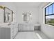 This bathroom features dual vanities, large windows, and marble countertops at 403 E Davis Blvd, Tampa, FL 33606