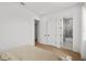 Minimalist bedroom design with wood floors and ensuite bathroom and walk in closet at 403 E Davis Blvd, Tampa, FL 33606