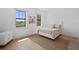 Bright bedroom with hardwood flooring, neutral colors, and large windows for lots of natural light at 403 E Davis Blvd, Tampa, FL 33606