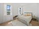 Bright bedroom featuring natural light, hardwood floors, neutral decor, and a comfortable bed at 403 E Davis Blvd, Tampa, FL 33606