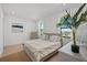 Sunlit bedroom with a comfortable bed, stylish linens, and a charming view of the neighborhood canal at 403 E Davis Blvd, Tampa, FL 33606