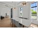 Elegant dining room with tray ceiling, modern lighting, and large windows at 403 E Davis Blvd, Tampa, FL 33606