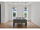 Elegant dining room with tray ceiling, modern lighting, and large windows at 403 E Davis Blvd, Tampa, FL 33606