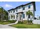 Stunning new construction home with a sleek exterior, beautiful landscaping, and a welcoming entrance at 403 E Davis Blvd, Tampa, FL 33606