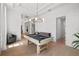 Bright game room featuring a pool table, tray ceiling, wainscoting, and hardwood floors at 403 E Davis Blvd, Tampa, FL 33606