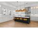 Bright kitchen with large island, stainless steel appliances, white cabinets, and eye-catching pendant lighting at 403 E Davis Blvd, Tampa, FL 33606